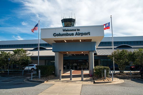 A large building with a sign that says welcome to columbus airport