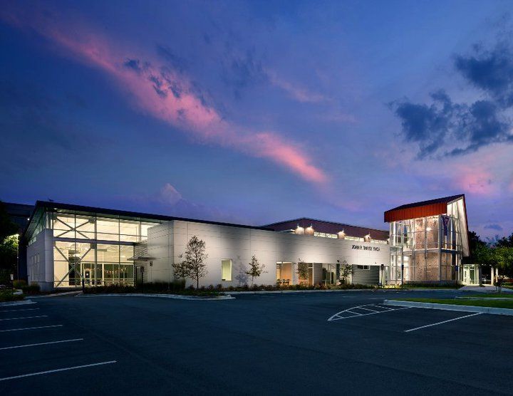 A large building with a parking lot in front of it