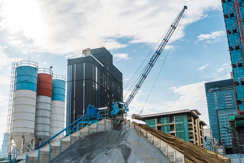 a large crane is on top of a pile of cement