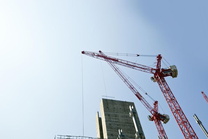 a group of cranes that are standing in the air