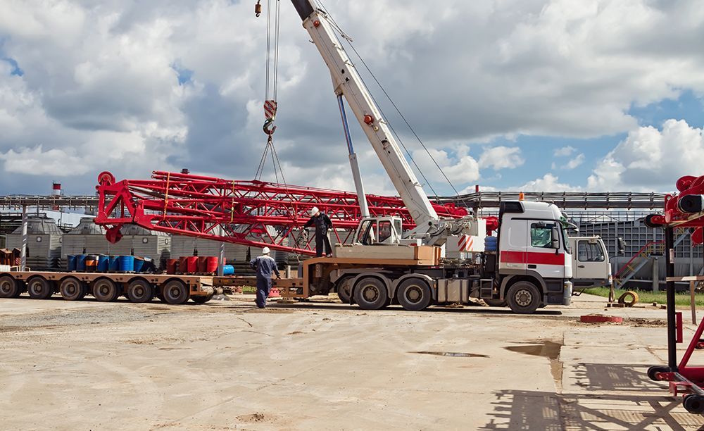 a crane is lifting a large piece of equipment