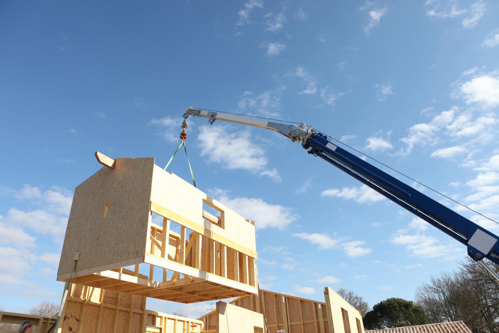 a crane is lifting a house up into the air
