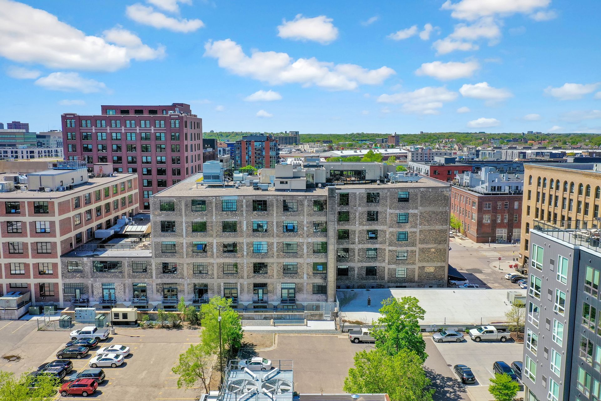 An aerial view of a city with a lot of buildings and a parking lot.
