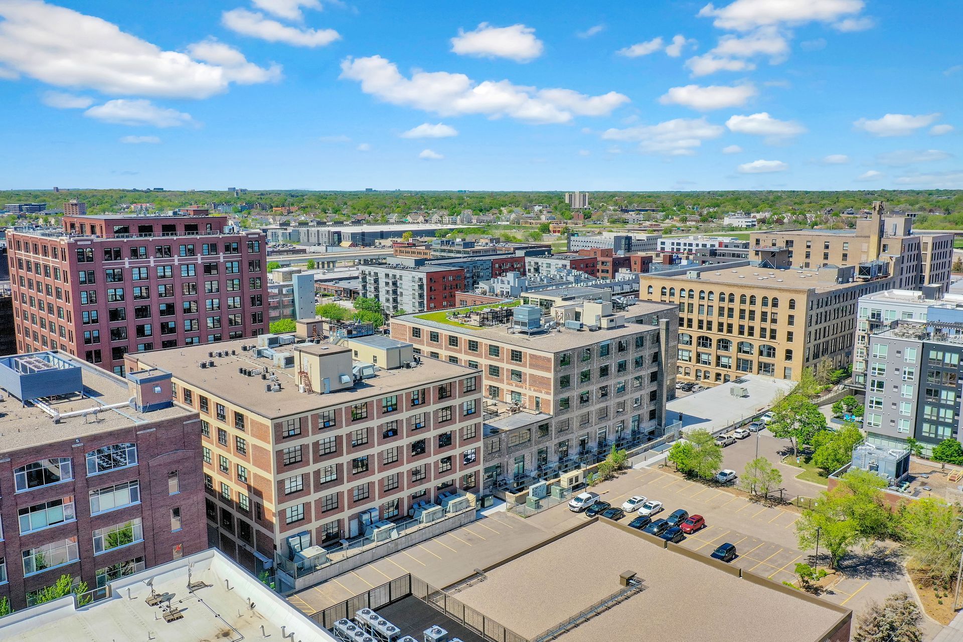 An aerial view of a city with lots of buildings and trees.