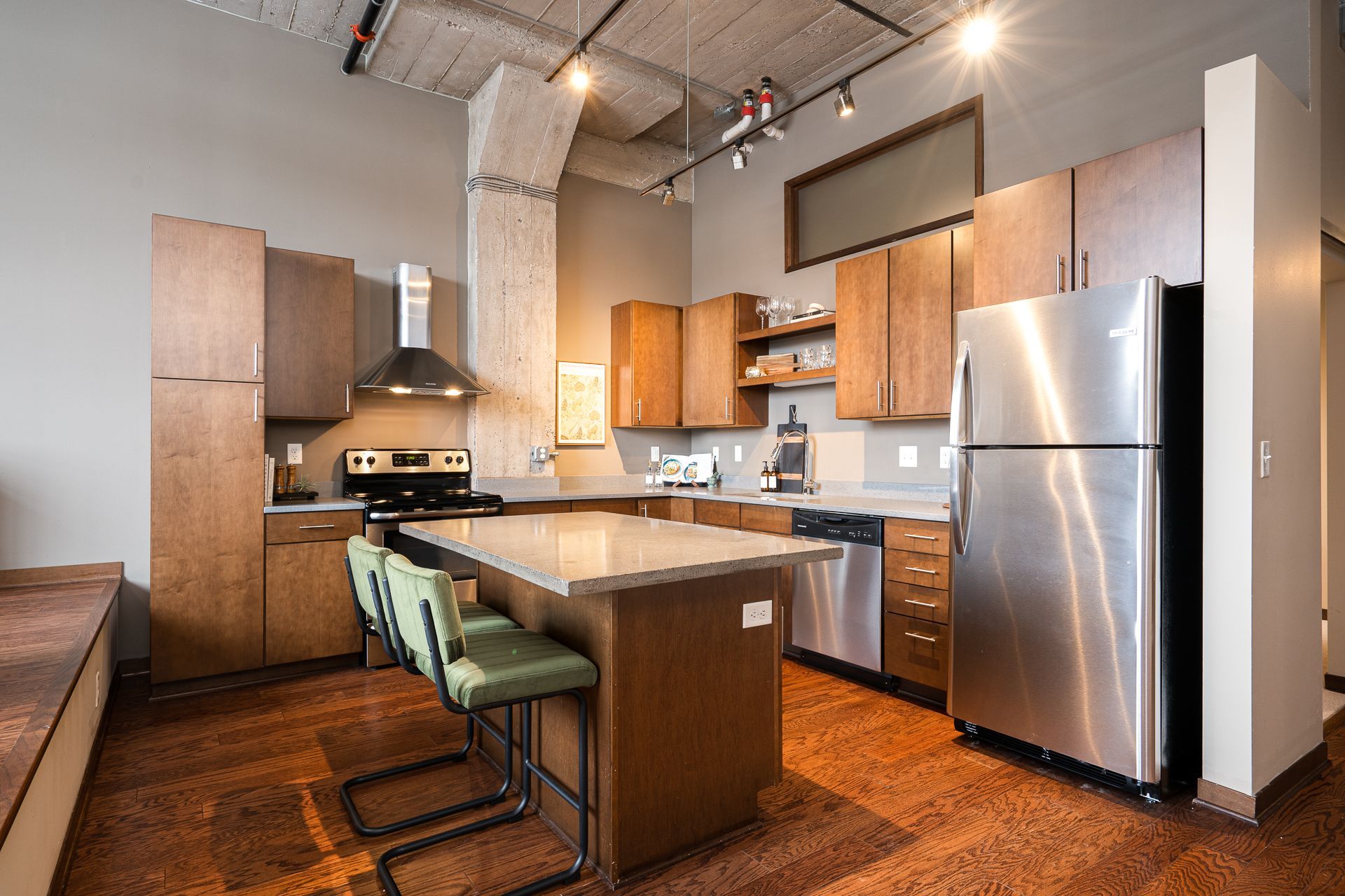 A kitchen with stainless steel appliances and wooden cabinets