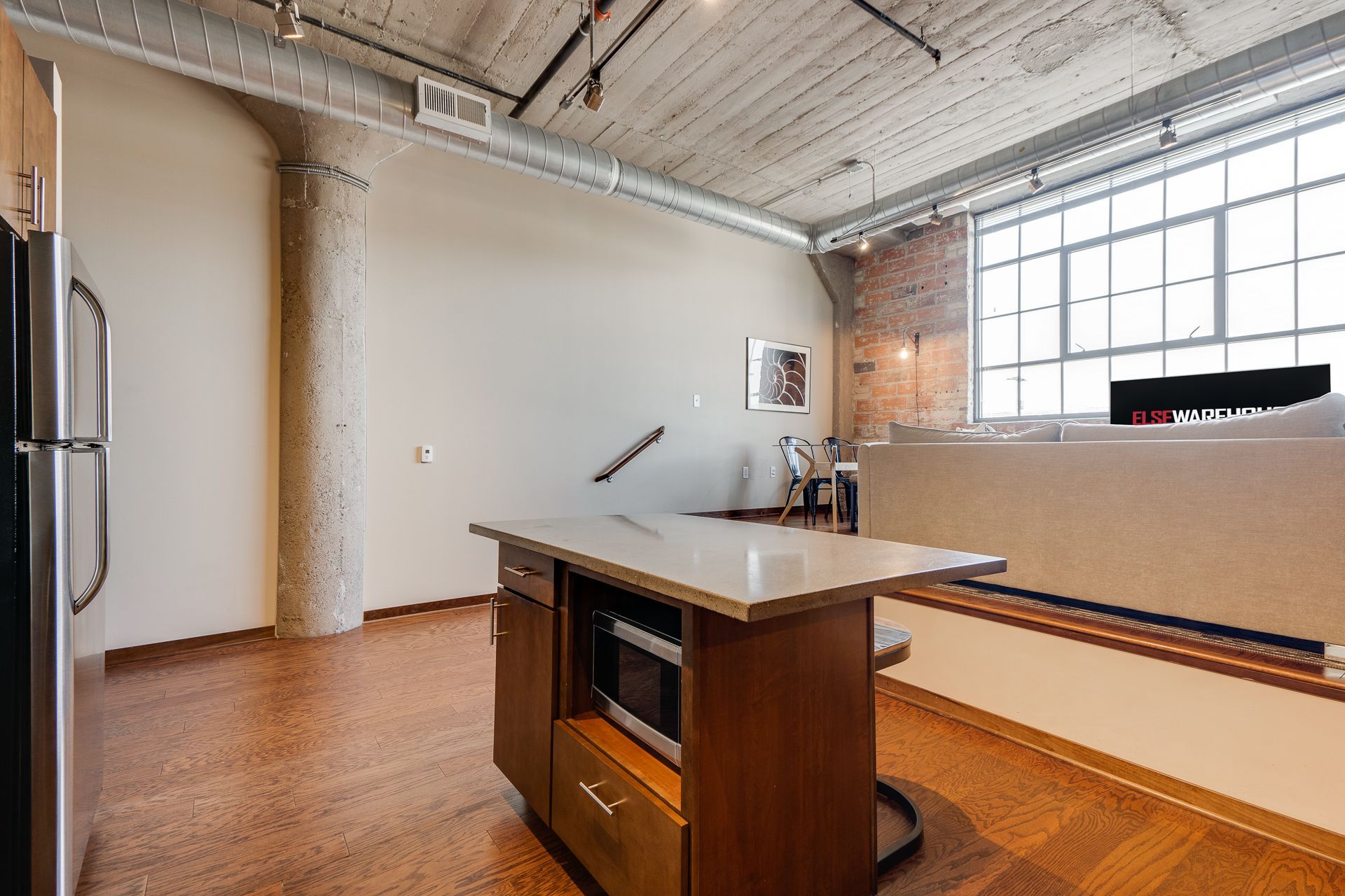 A kitchen with a large island and a refrigerator