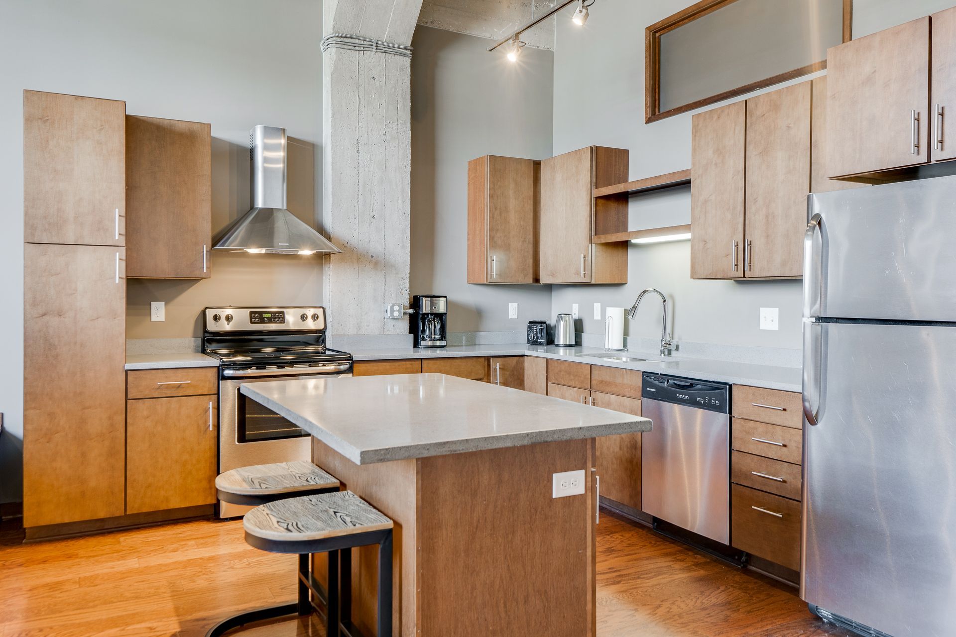 A kitchen with stainless steel appliances and wooden cabinets