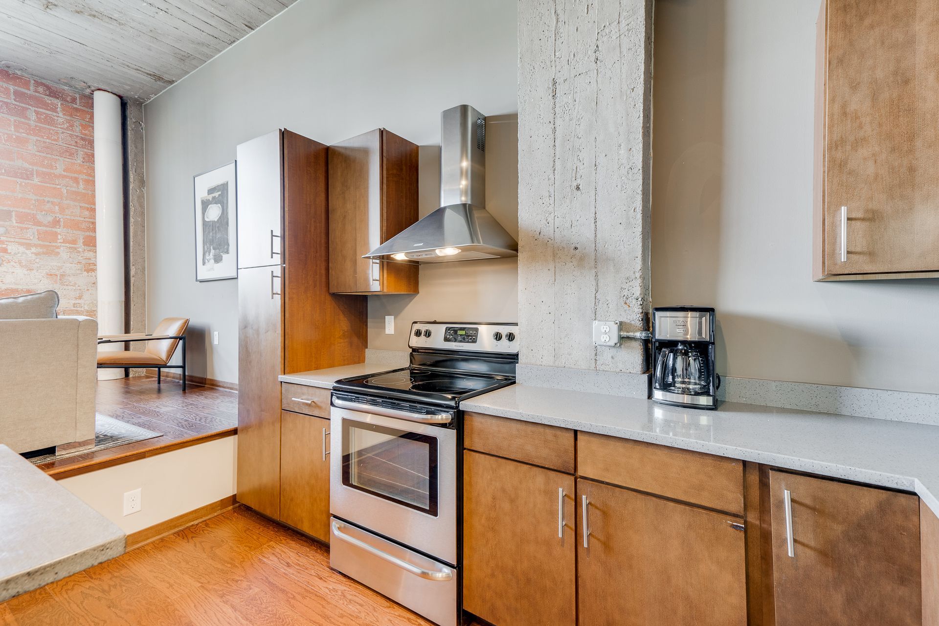 A kitchen with stainless steel appliances and wooden cabinets