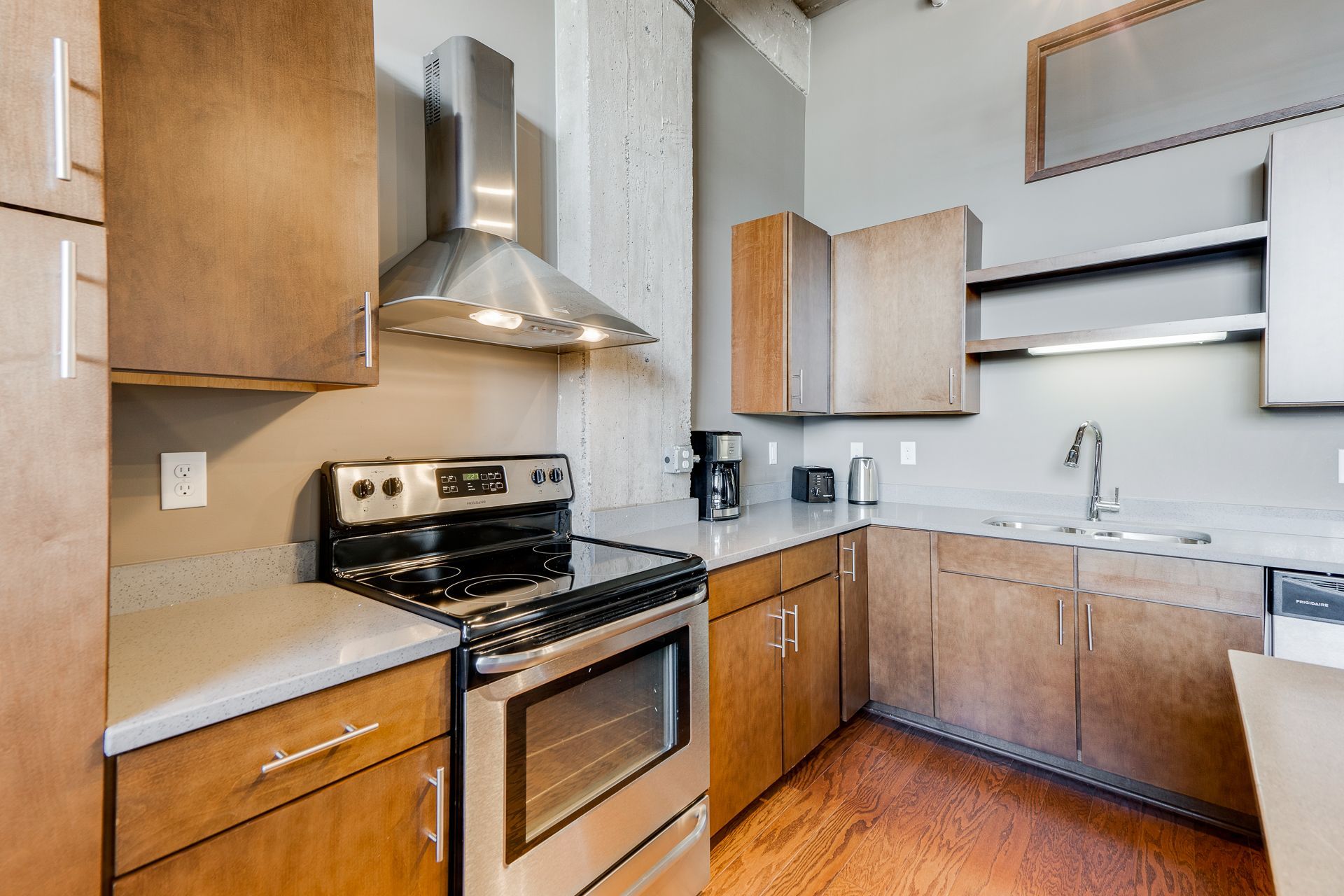A kitchen with stainless steel appliances and wooden cabinets
