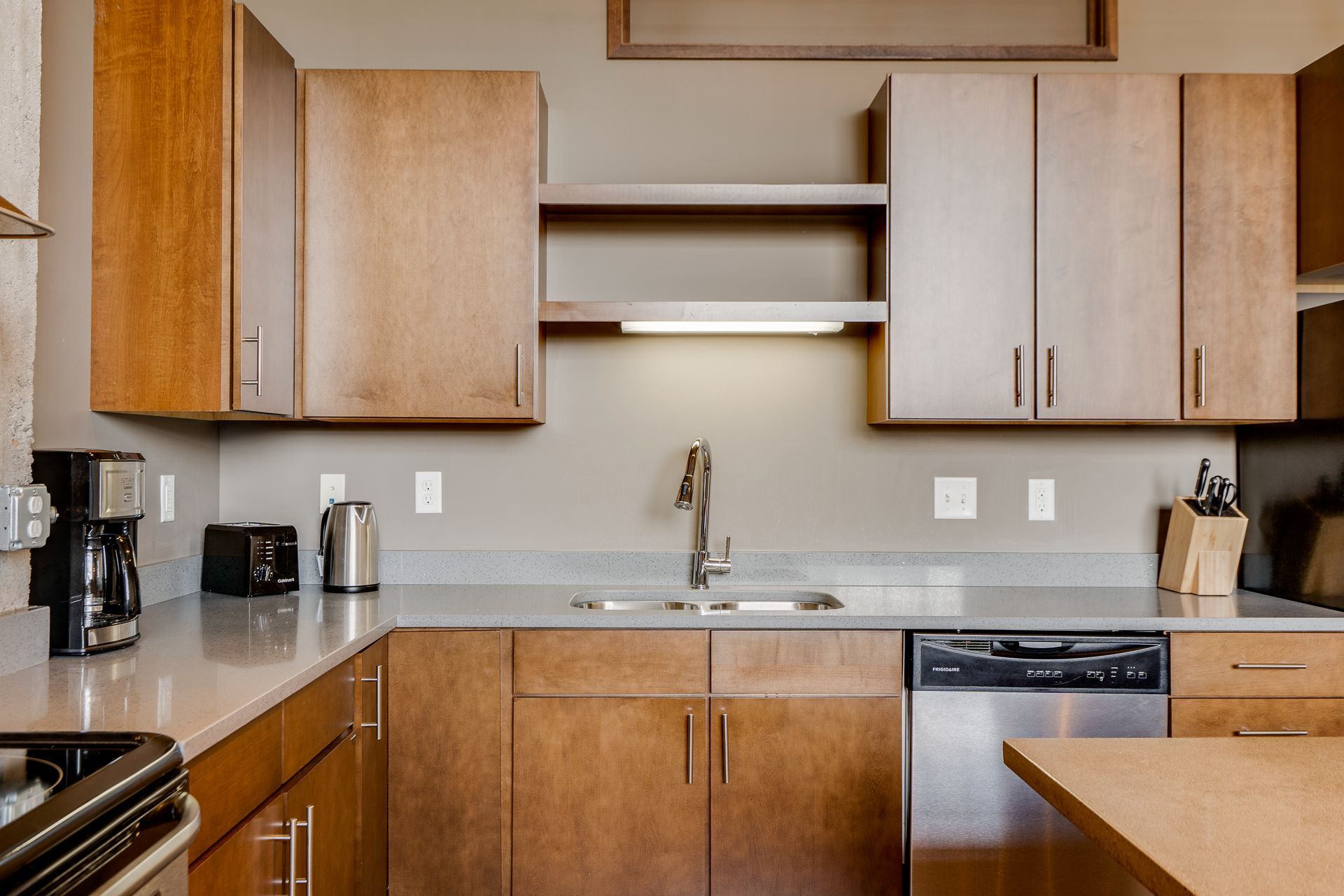A kitchen with wooden cabinets and stainless steel appliances
