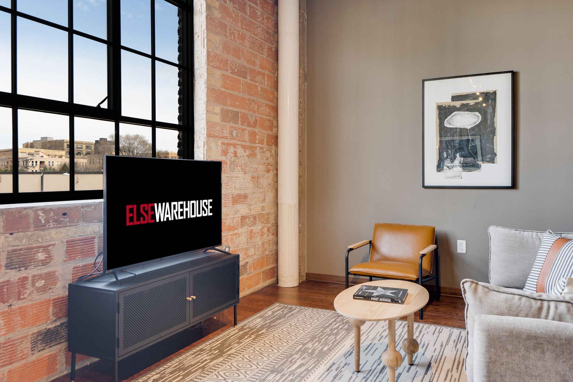 A living room with a flat screen tv on a stand.
