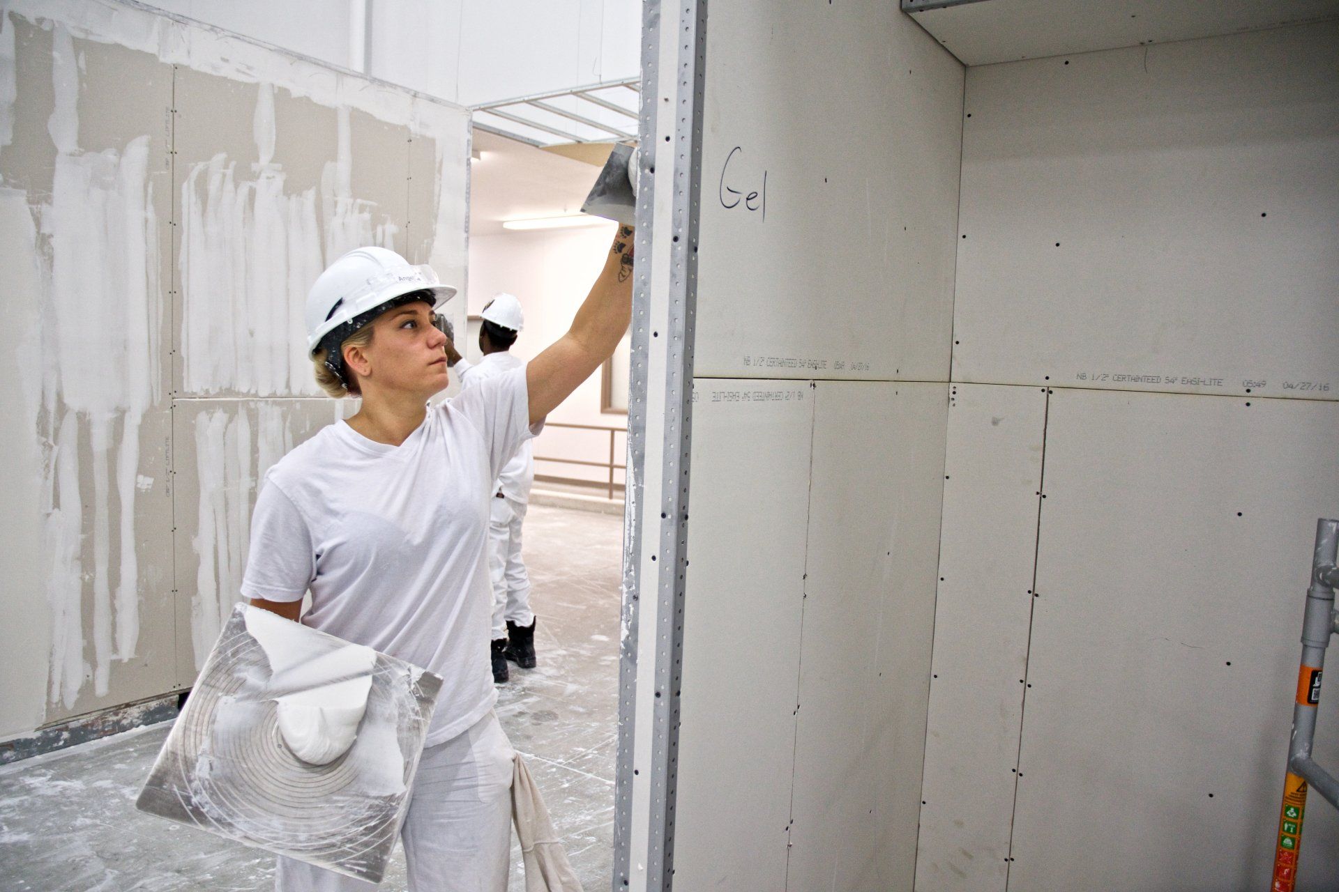 Photo of woman drywalling