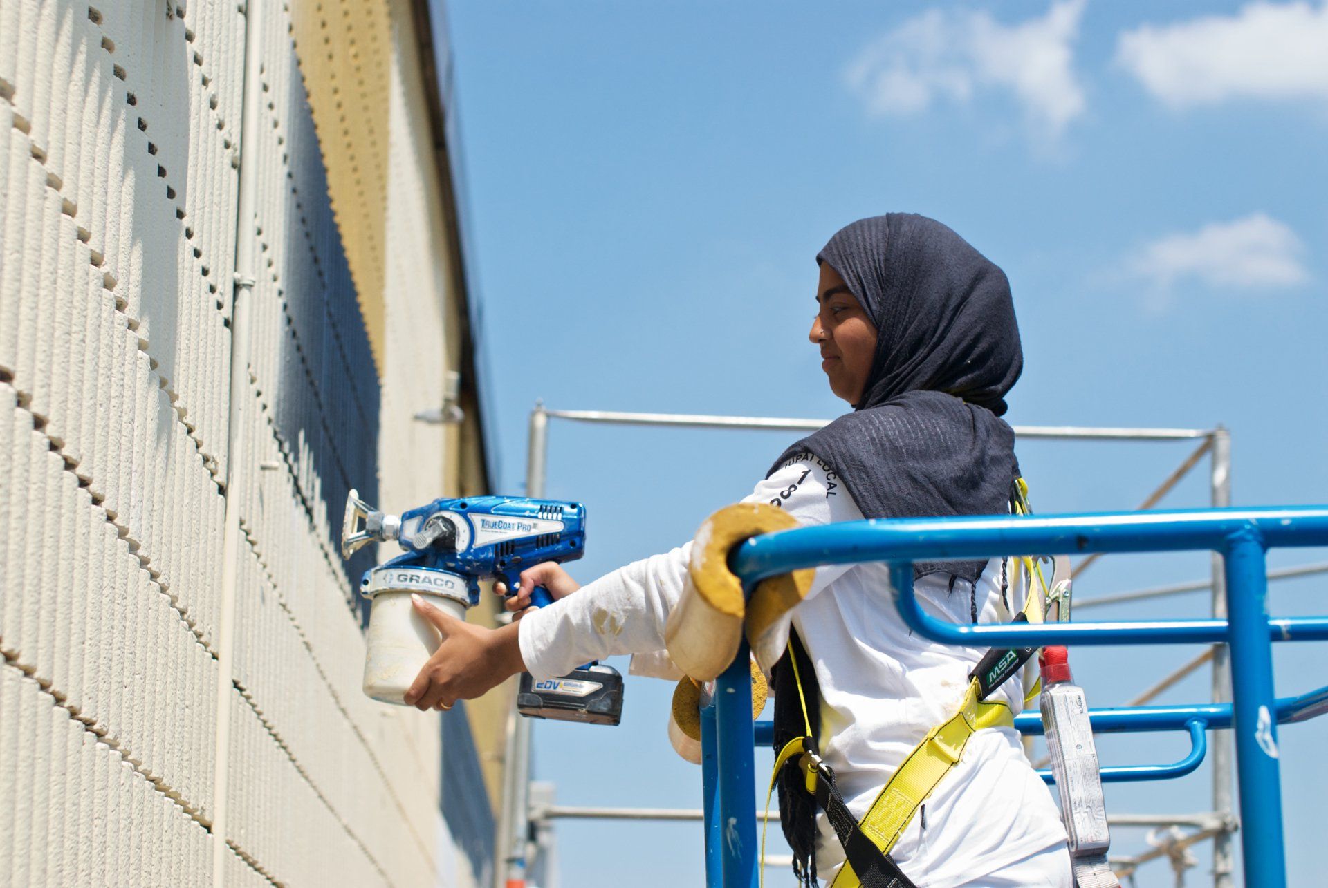Photo of woman painting exterior