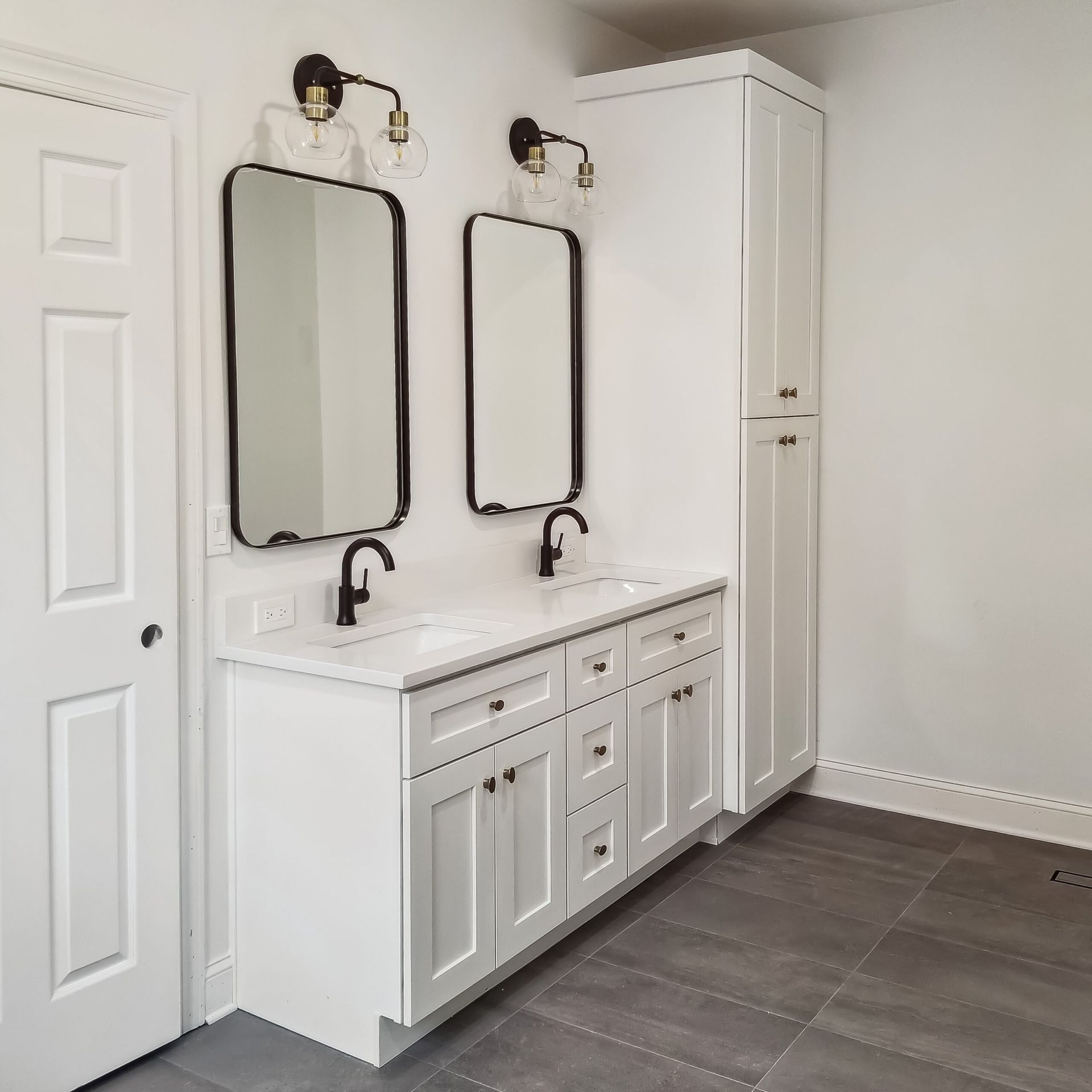 A bathroom with a walk in shower and a glass door.