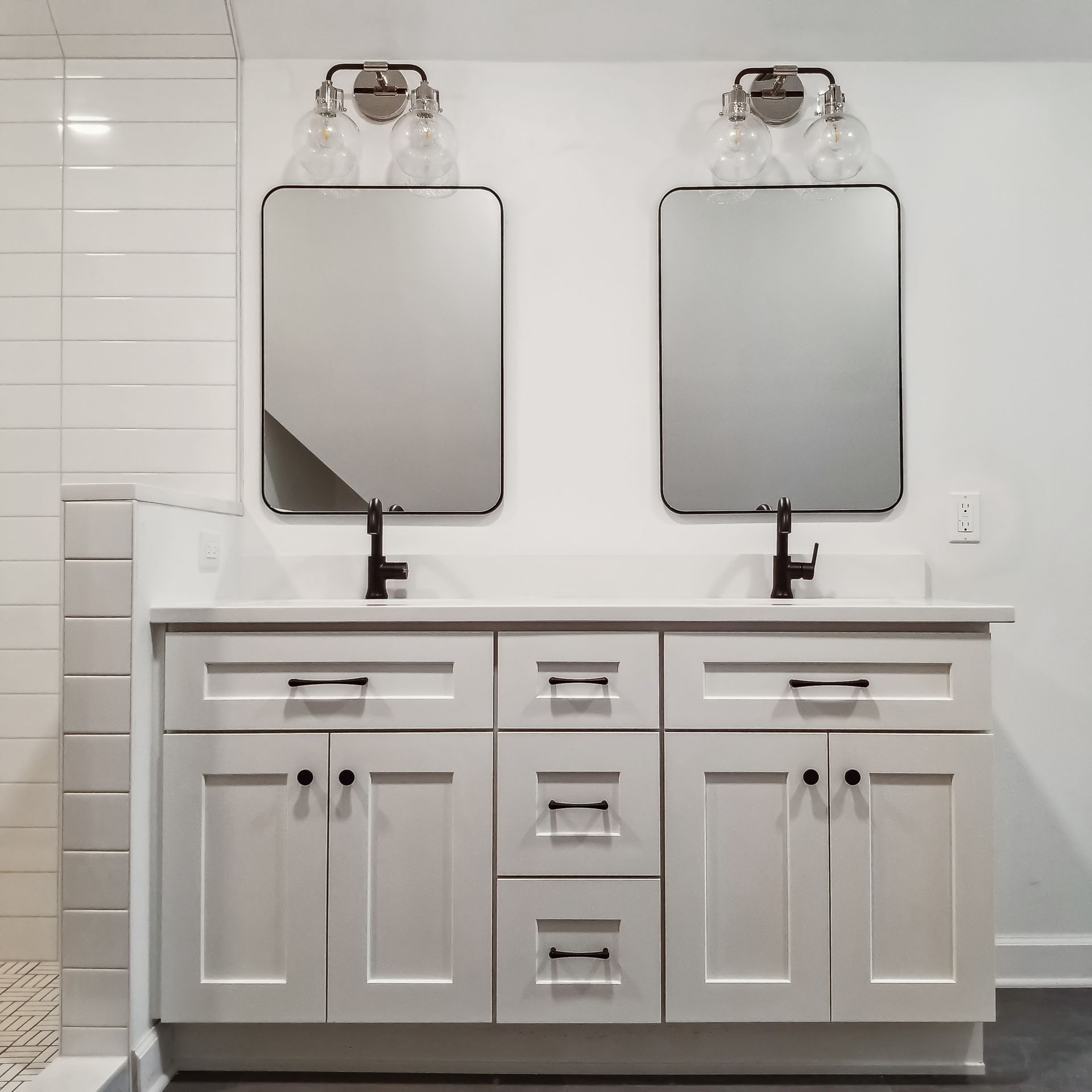 A bathroom with two sinks and two mirrors
