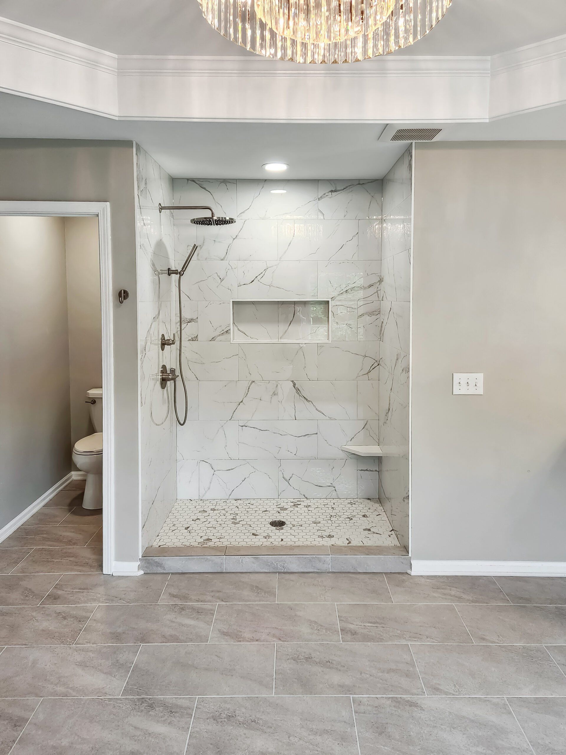 A bathroom with a walk in shower and a toilet.