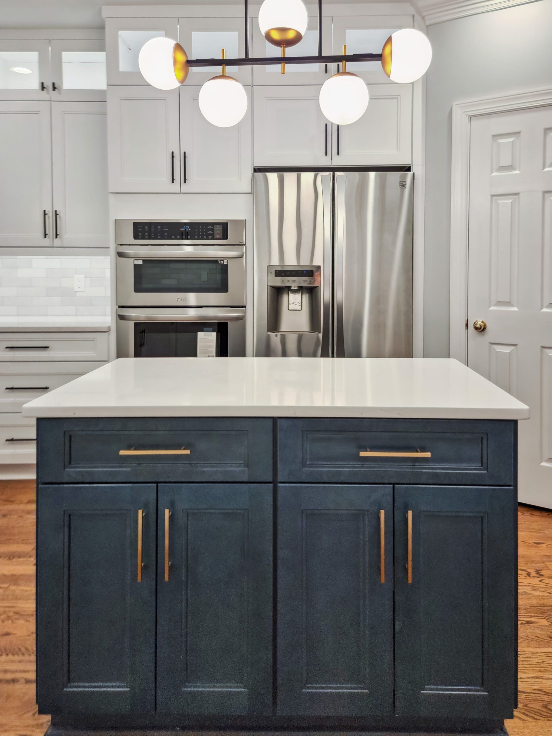 A kitchen with stainless steel appliances and a large island