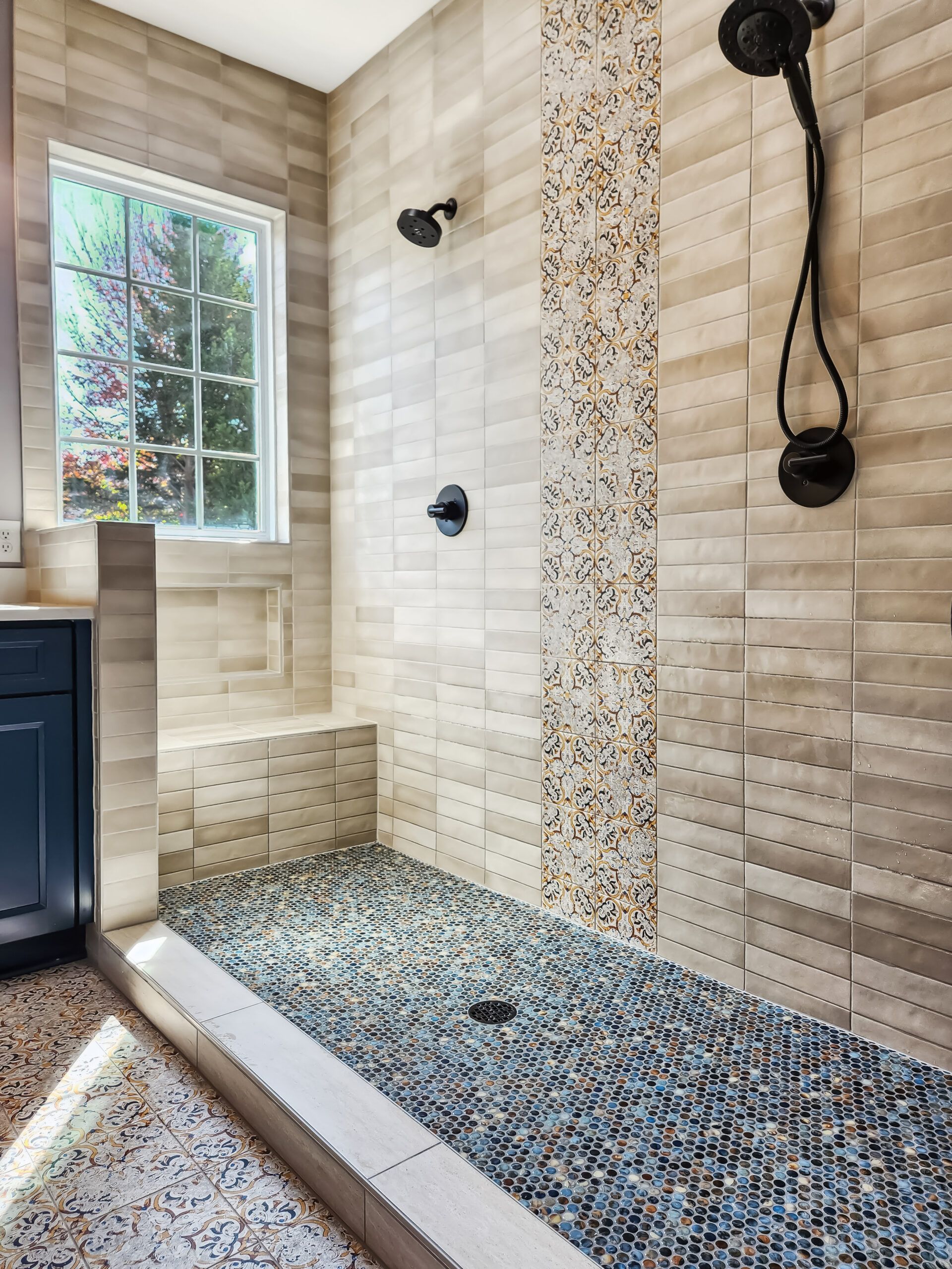 A bathroom with a walk in shower and a window