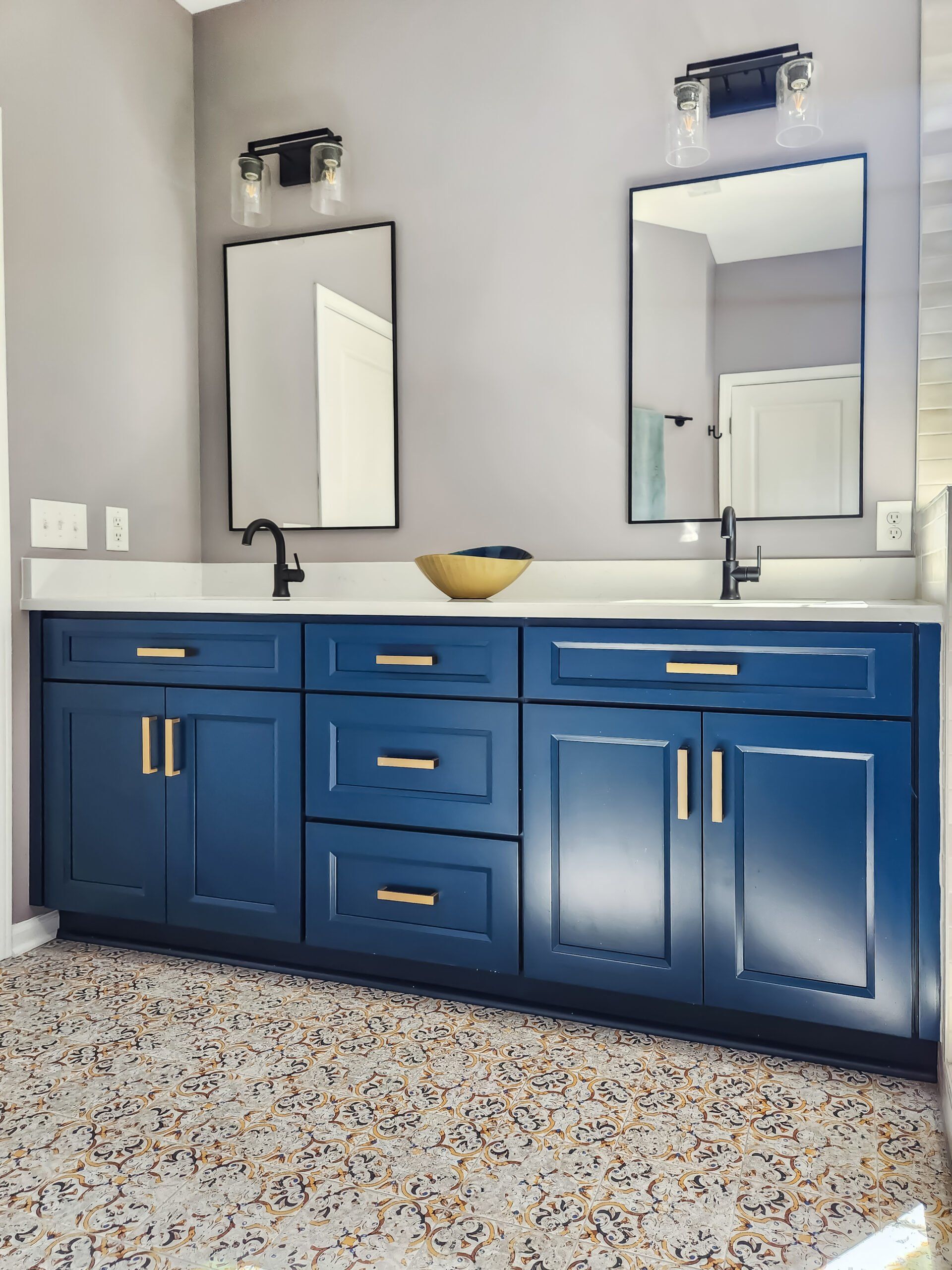 A bathroom with two sinks and two mirrors