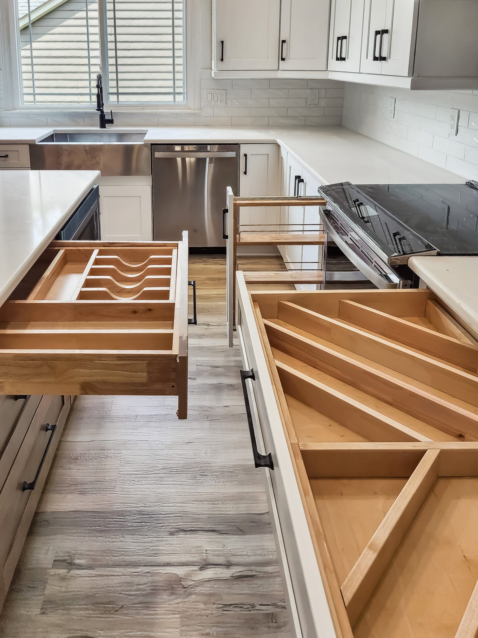 A kitchen with wooden drawers and a stove top oven