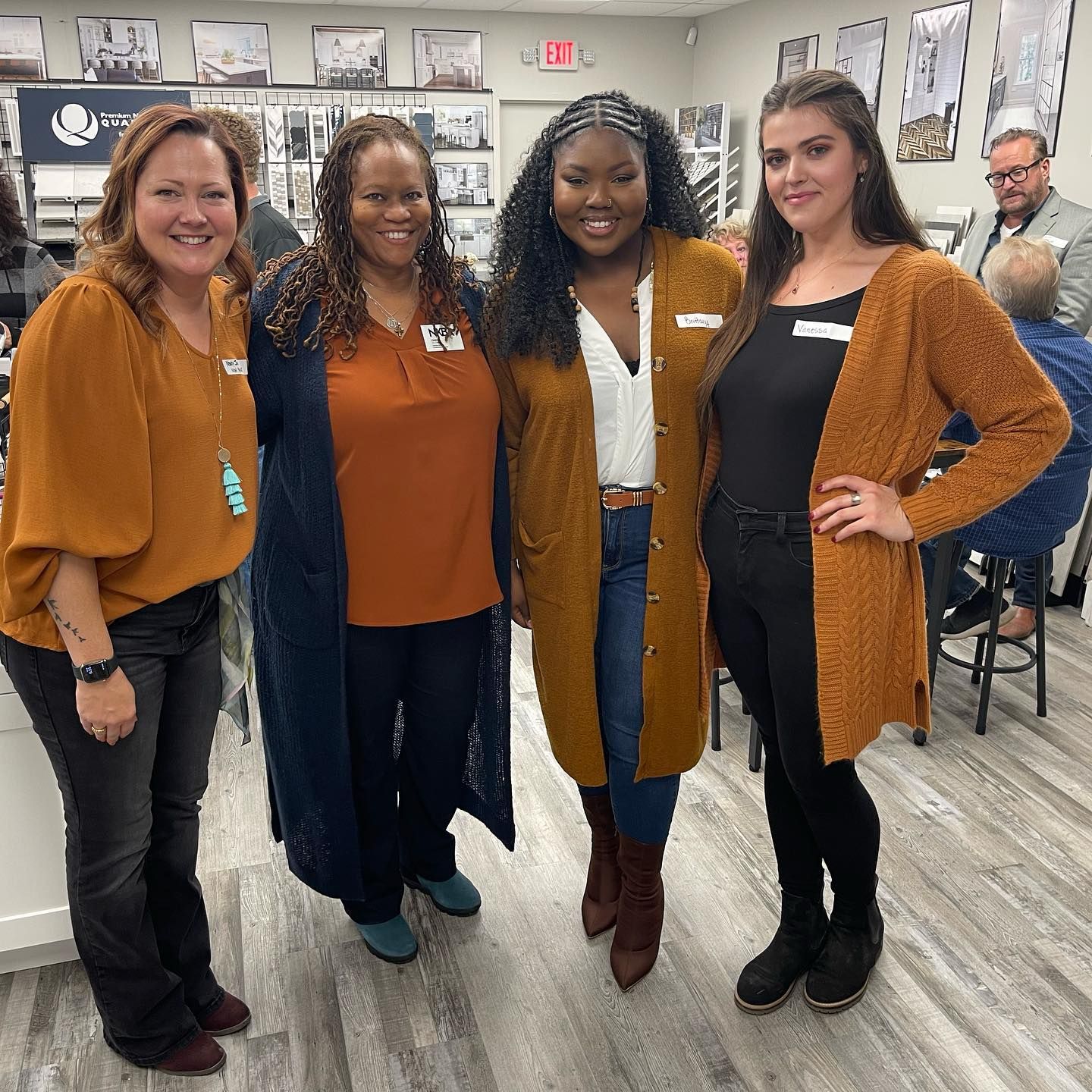 A group of women are posing for a picture together in a room.