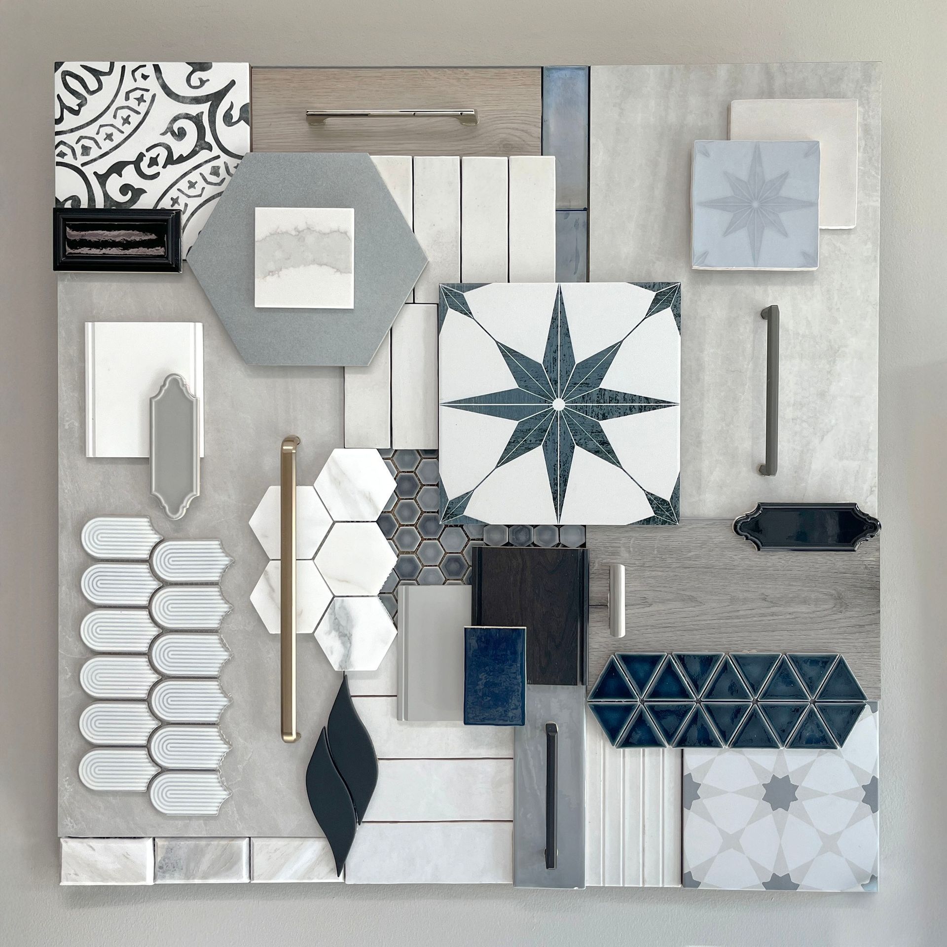 A collage of tiles , wood , and other items on a wall.