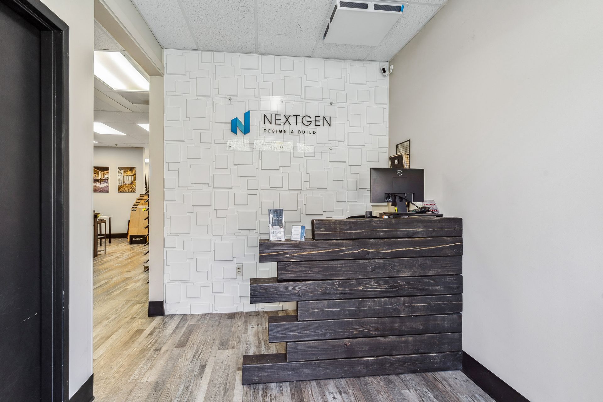 A reception area with a wooden counter and a sign on the wall.