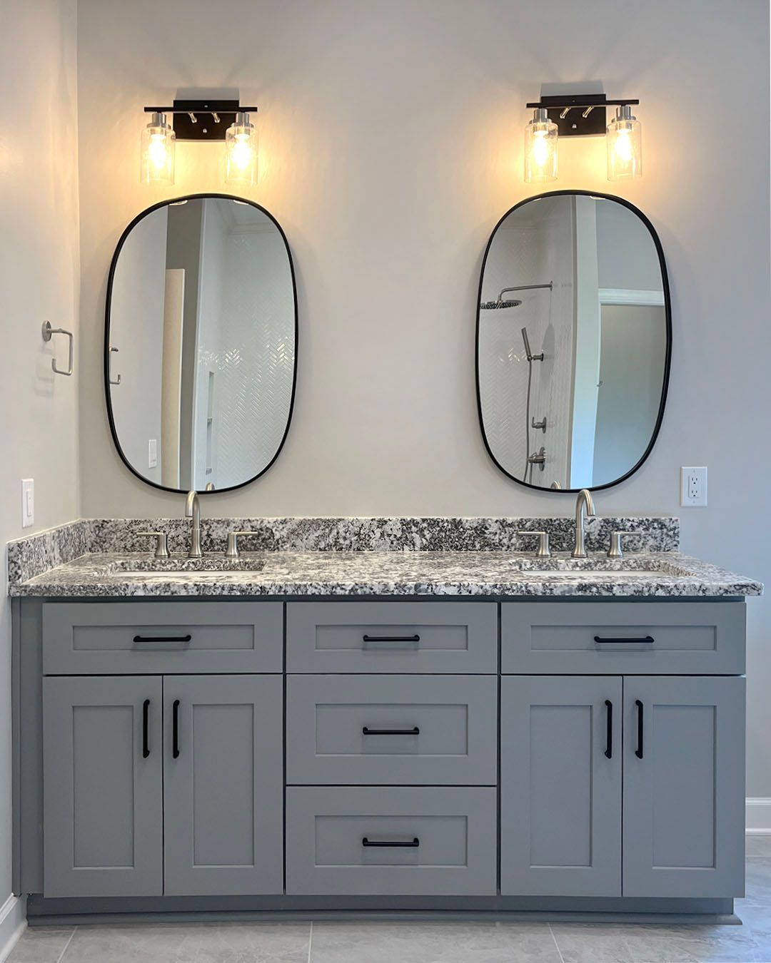 A bathroom with two sinks and two mirrors.