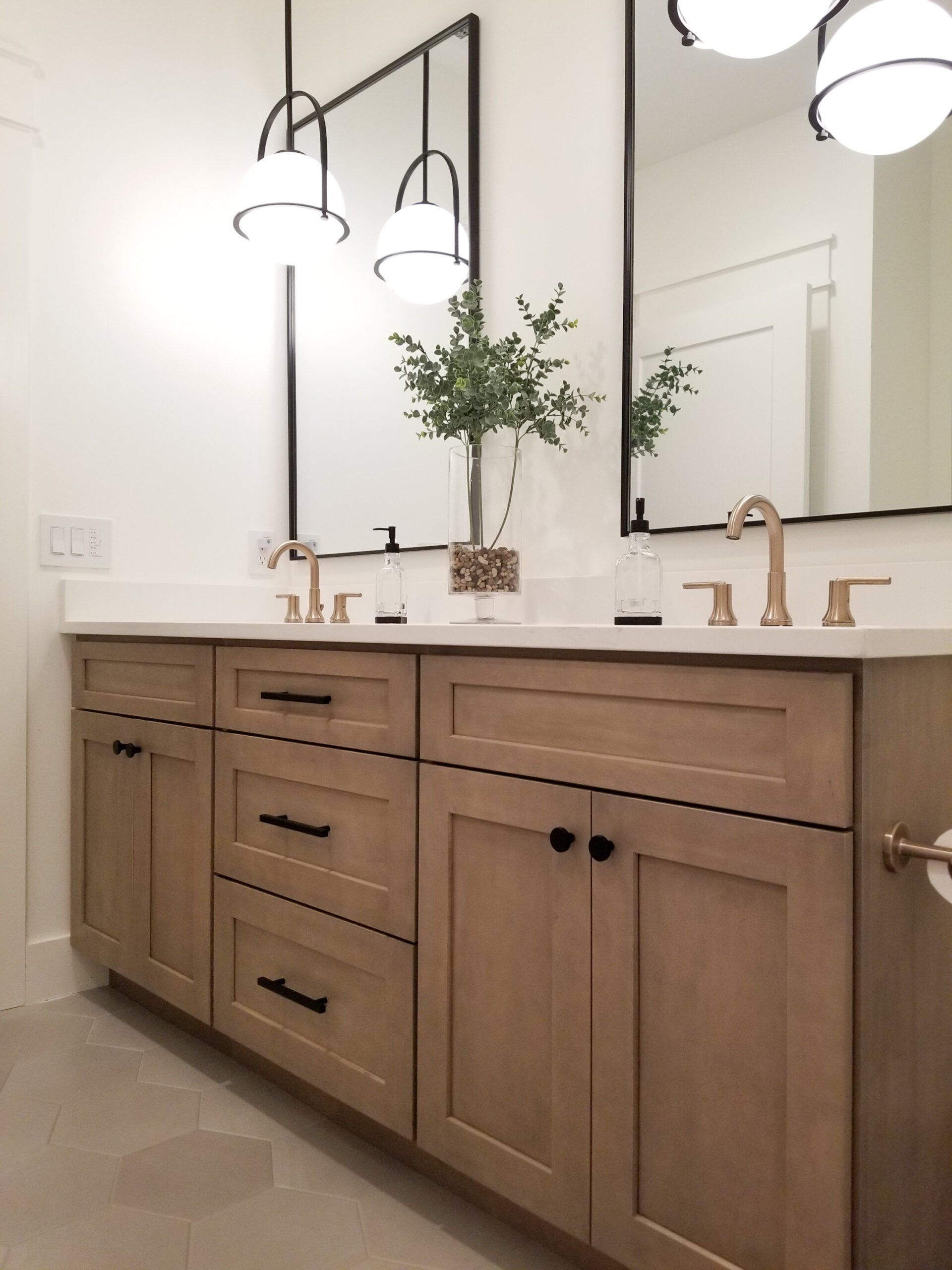 A bathroom with two sinks and two mirrors