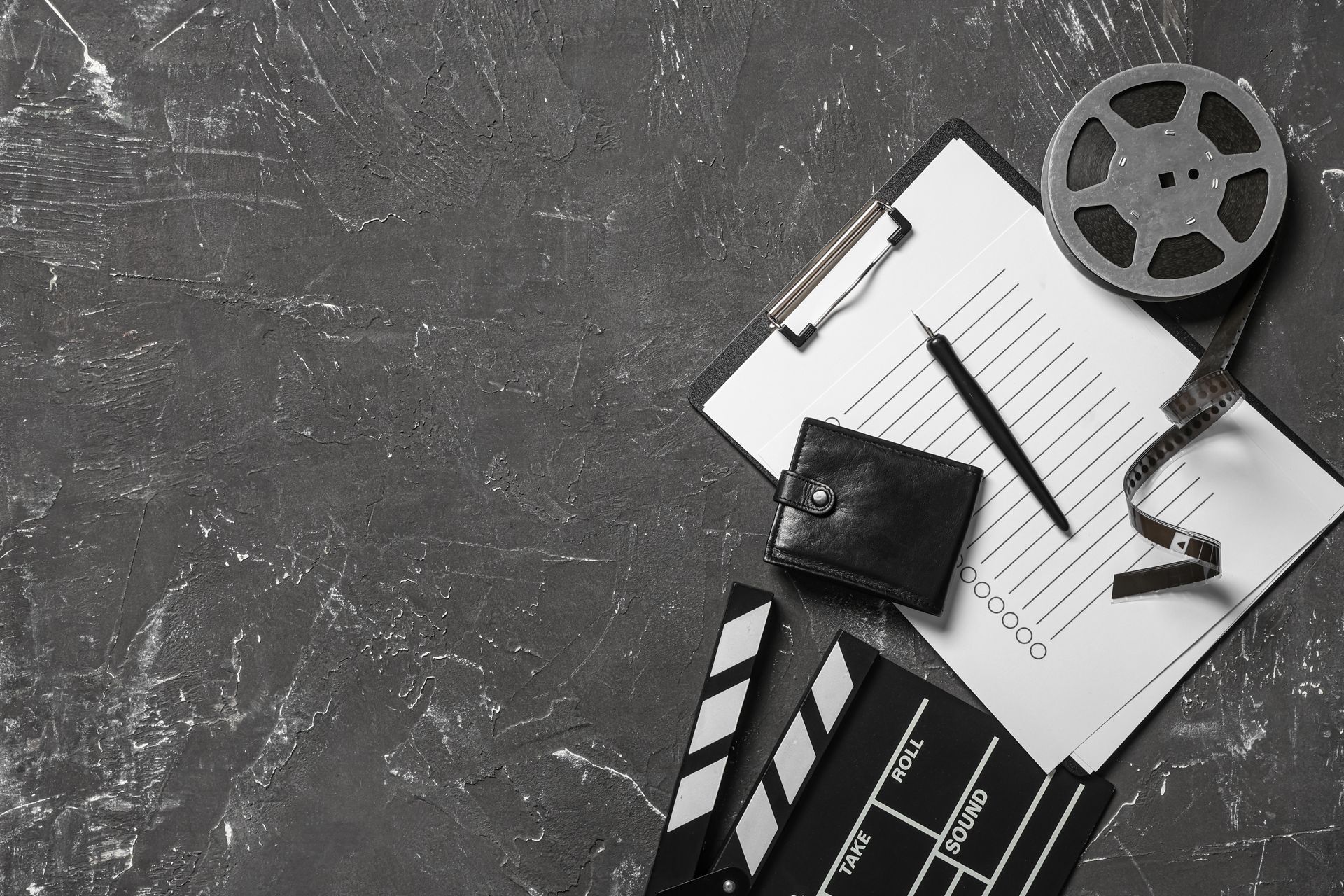 Silhouette of a musician on stage, holding a guitar. Backlit by spotlights in smoky atmosphere.