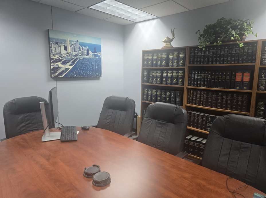 Conference room with a wooden table, chairs, bookshelves, and a cityscape painting.