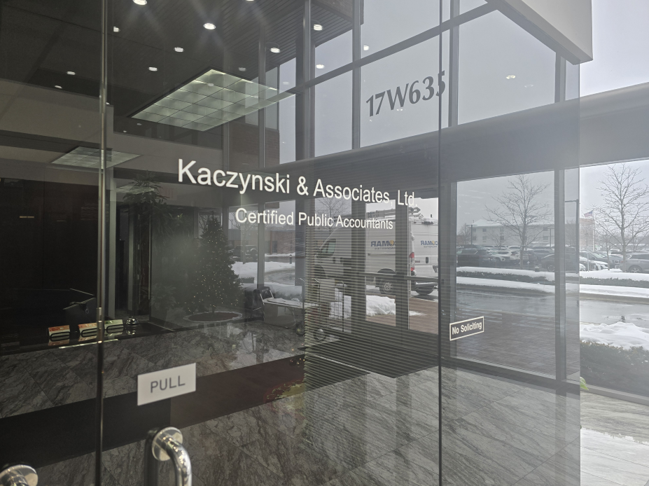 Entrance to Kaczynski & Associates, Certified Public Accountants. Glass door with address 17 W63rd visible.