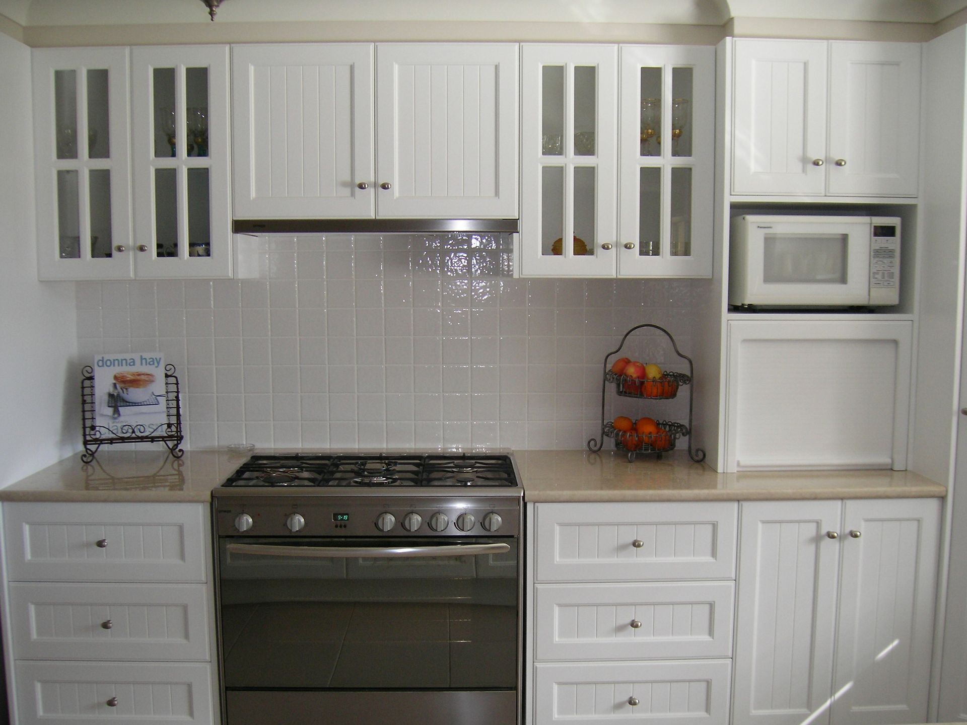 Small White Kitchen with Gray Tile Backsplash, White Cabinets, Sink, Washing Machine — Simmonds Kitchens in Walcha, NSW