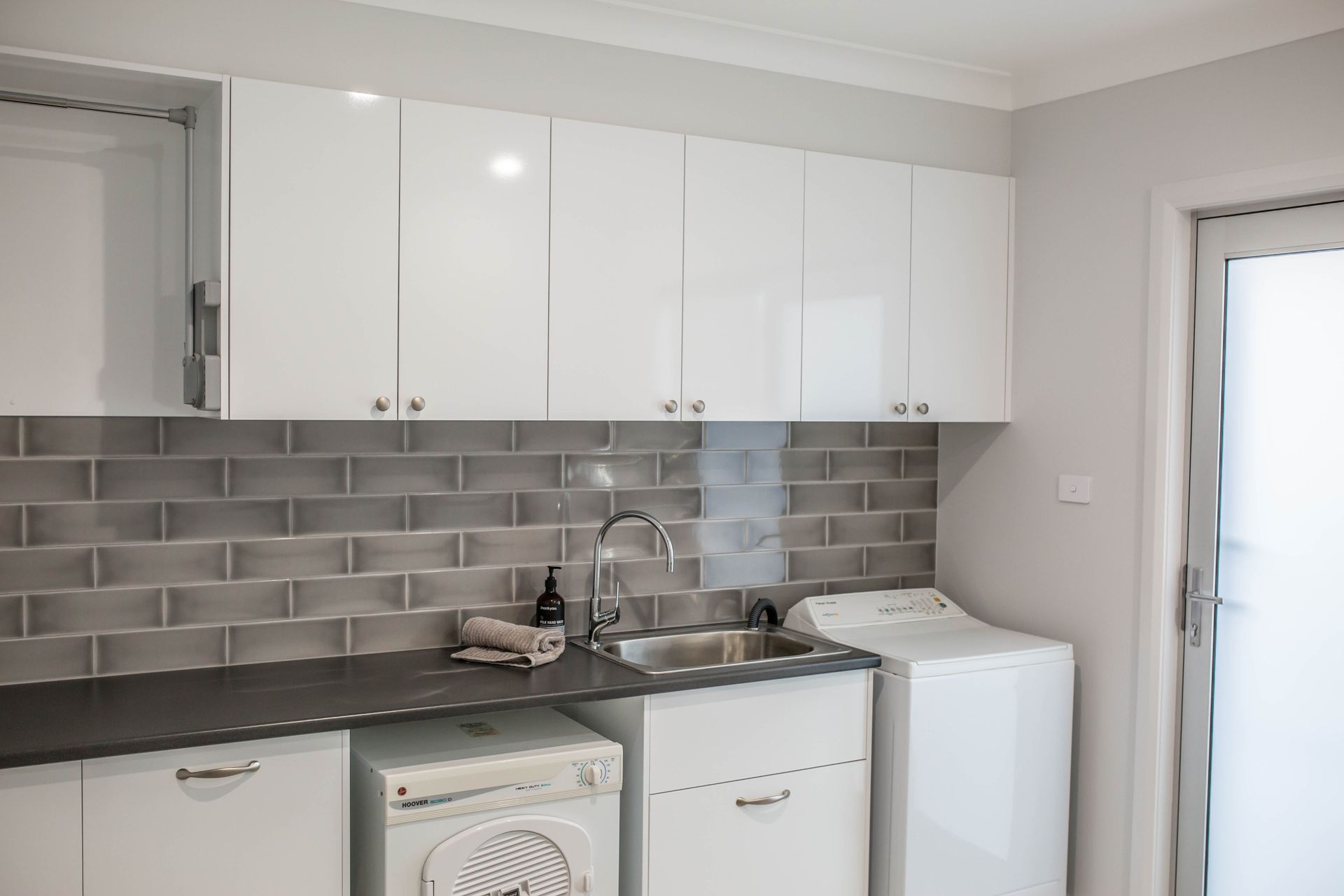 White Kitchen with Cabinets, Stove, Microwave, and Tiled Backsplash — Simmonds Kitchens in Walcha, NSW