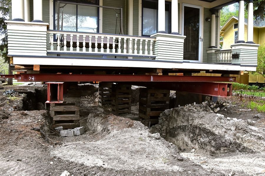 a house that is under construction with a truck underneath it