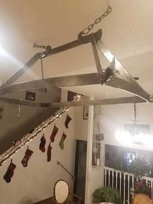 A living room decorated for christmas with stockings hanging from the ceiling.