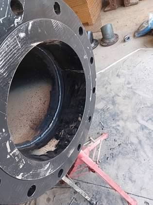 A large black pipe is sitting on top of a red stand.