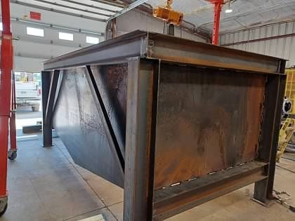 A large metal structure is sitting in a building.