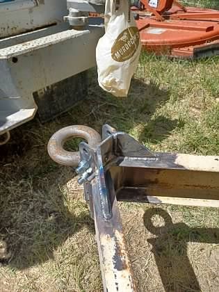 A bag is hanging from a hook on a trailer.