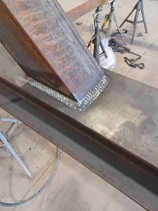 A piece of metal is sitting on top of a wooden table.