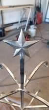 A metal table with a star on top of it.