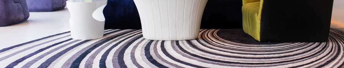 table and sofa on a swirly patterned carpet