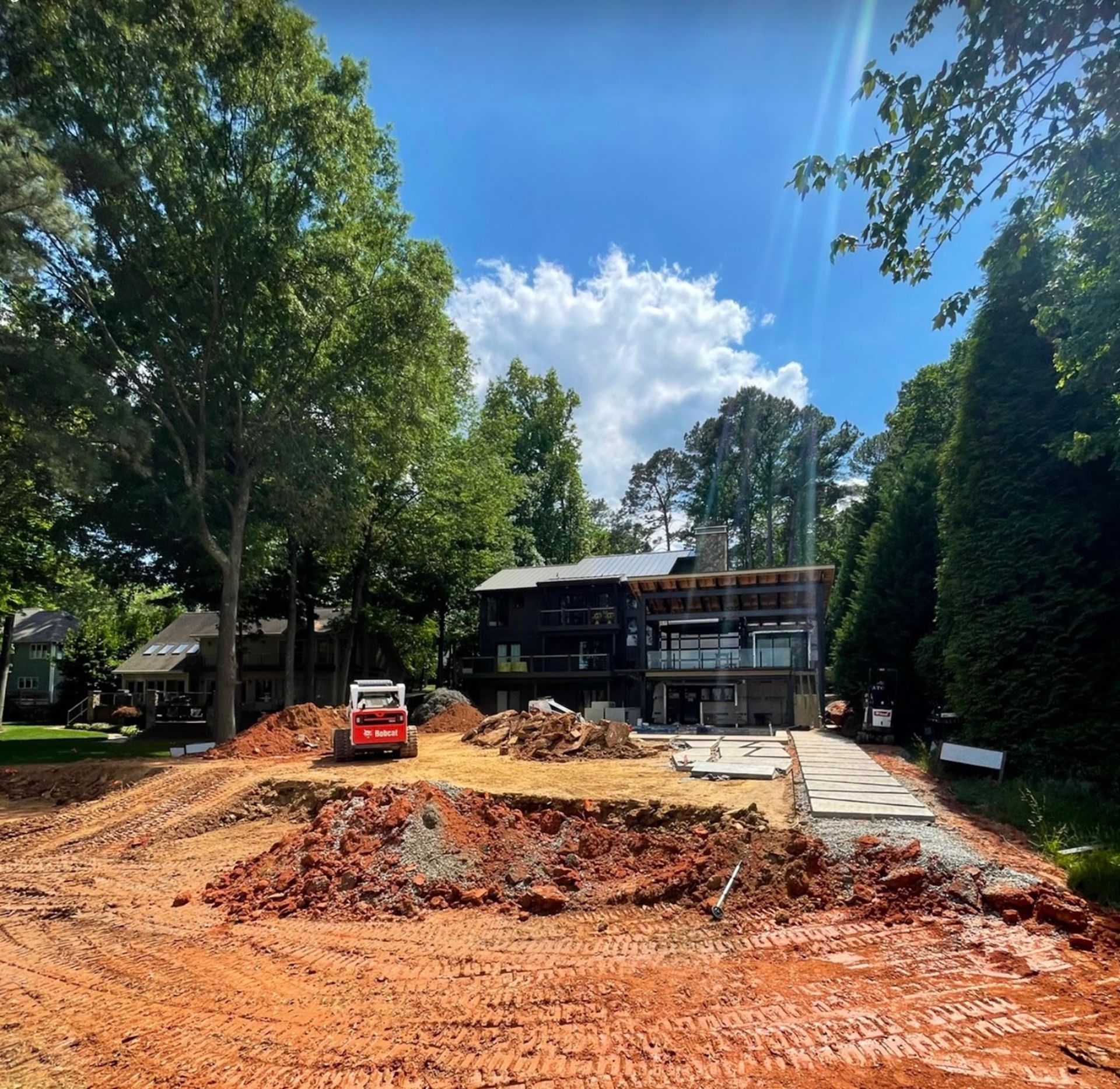 A construction site with a house in the background