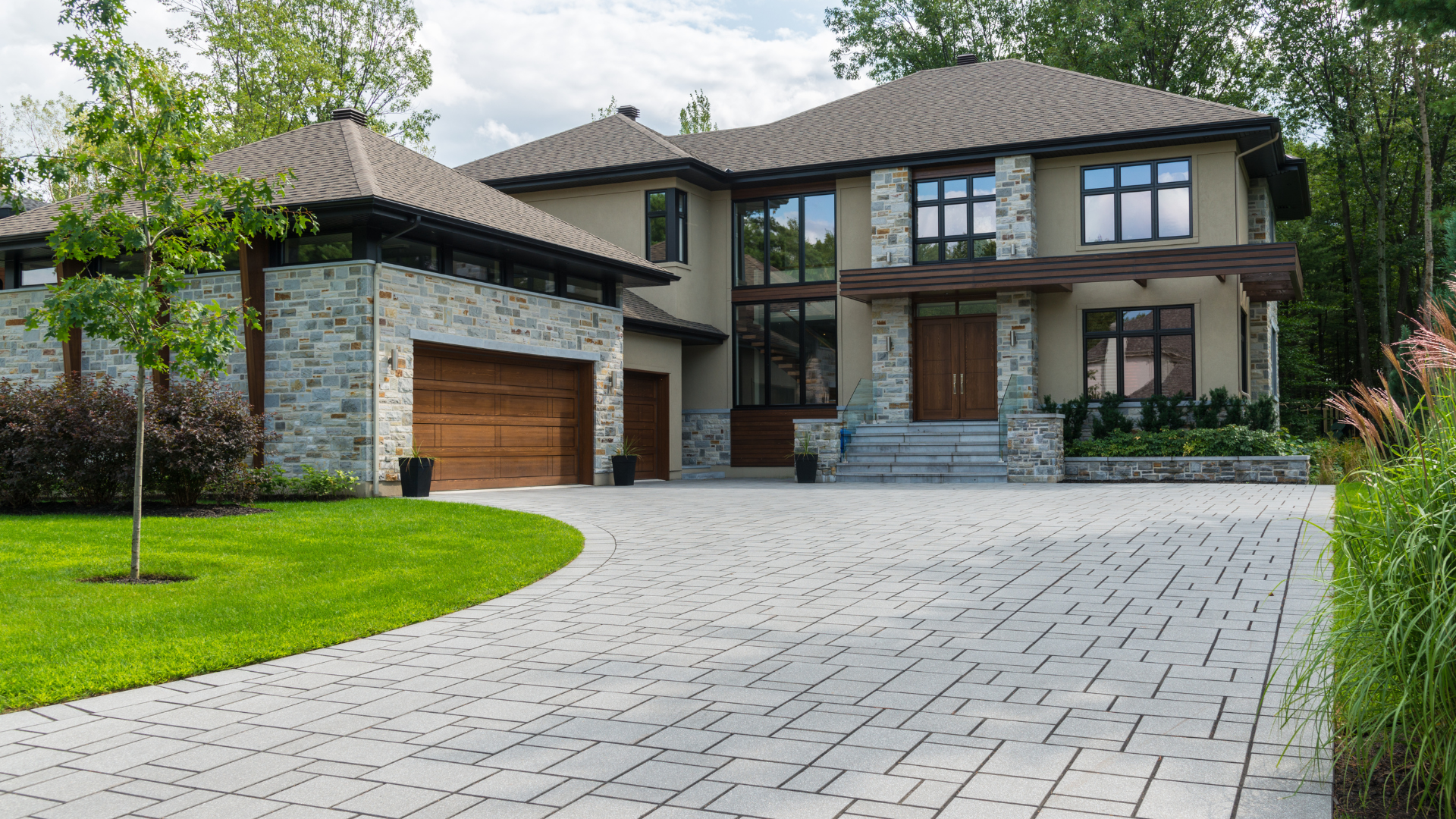 A large house with a large driveway in front of it.