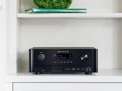 Black Anthem receiver on a white shelf, with a small display and knobs.
