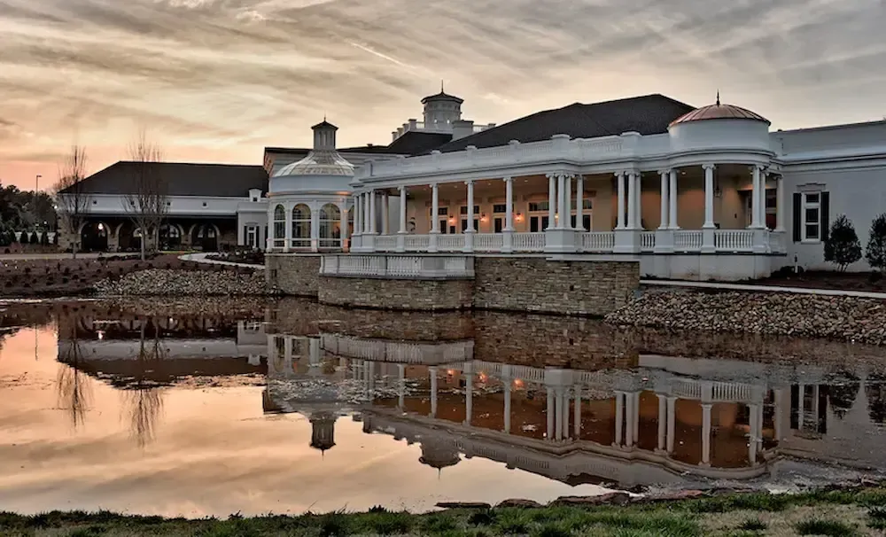 There is a waterfall in the middle of a river surrounded by trees.