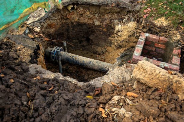 A pipe is being installed in a hole in the ground.
