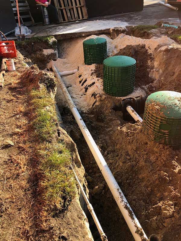 A septic system is being installed in a hole in the ground.