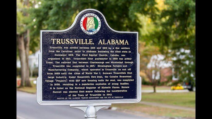 A historical marker for trussville alabama is sitting on a pole.