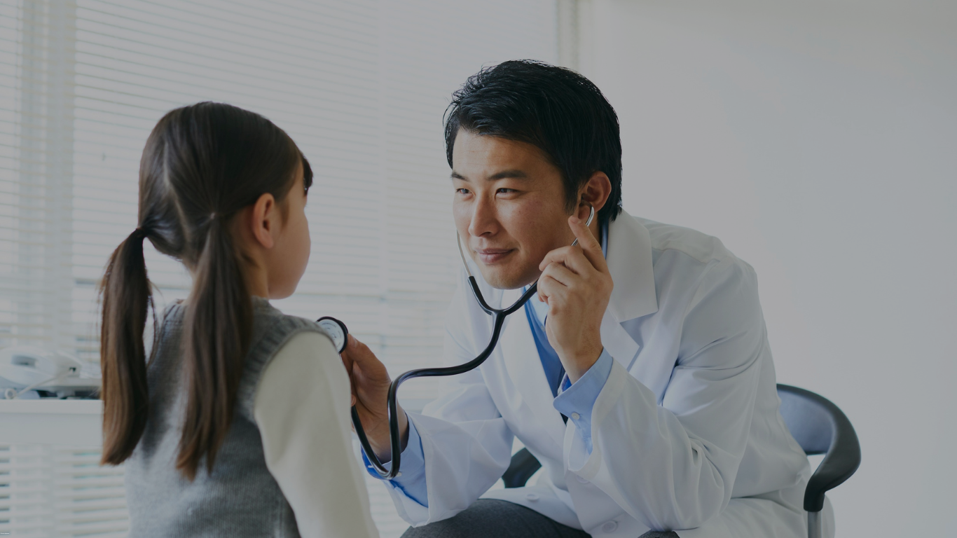 A little girl is giving a high five to a doctor.